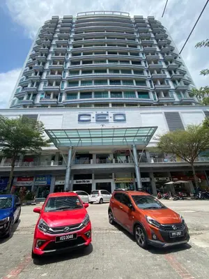 two cars parked in front of a large building at 6PAX ONE BEDROOM SOHO near USM SPICE ARENA PANTAI SPECIALIST AIRPORT in Bayan Lepas