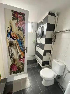 a bathroom with a toilet and a painting on the wall at 6PAX ONE BEDROOM SOHO near USM SPICE ARENA PANTAI SPECIALIST AIRPORT in Bayan Lepas