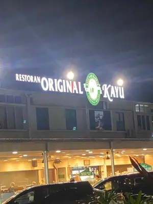 a restaurant original kiwi sign on top of a building at 6PAX ONE BEDROOM SOHO near USM SPICE ARENA PANTAI SPECIALIST AIRPORT in Bayan Lepas