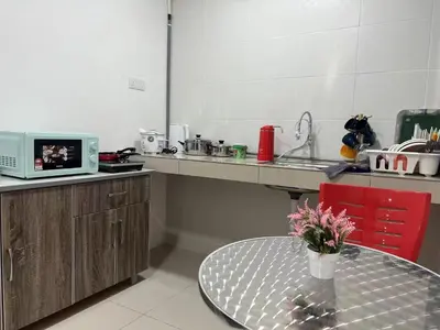a kitchen with a table in the middle of a kitchen at Cozy homestay Manhattan Ipoh,12 pax \u6021\u4fdd\u6c11\u5bbf in Ipoh
