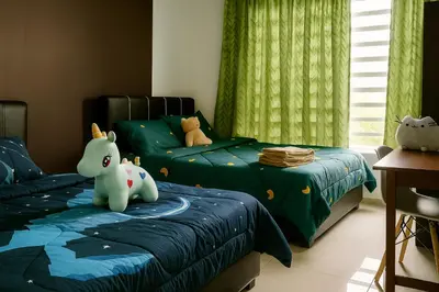 two beds with stuffed animals on them in a bedroom at Cozy homestay Manhattan Ipoh,12 pax \u6021\u4fdd\u6c11\u5bbf in Ipoh