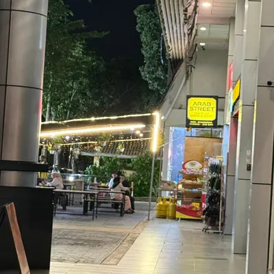 a restaurant with people sitting at tables at night at 4 PAX ONE BEDROOM SOHO near USM SPICE ARENA AIRPORT MUTIARA SPECIALIST in Bayan Lepas