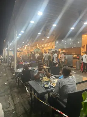 a group of people sitting at tables in a building at 4 PAX ONE BEDROOM SOHO near USM SPICE ARENA AIRPORT MUTIARA SPECIALIST in Bayan Lepas