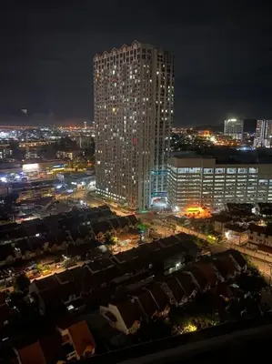 a view of a city at night with a tall building at 4 PAX ONE BEDROOM SOHO near USM SPICE ARENA AIRPORT MUTIARA SPECIALIST in Bayan Lepas