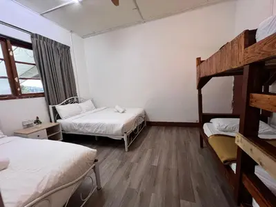 a room with two beds and a bunk bed at Mountain View Guesthouse Cameron Highlands in Tanah Rata