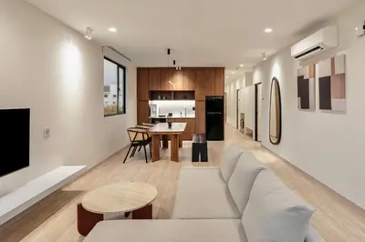 a living room with a couch and a table at Codrington House - Boutique Apartments in George Town