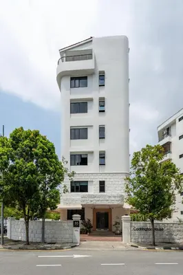 a white building with a tower at Codrington House - Boutique Apartments in George Town