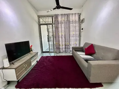 a living room with a couch and a flat screen tv at Cozy24#4pax#wifi&netflix#NearAeonAlma#Heritage in Bukit Mertajam