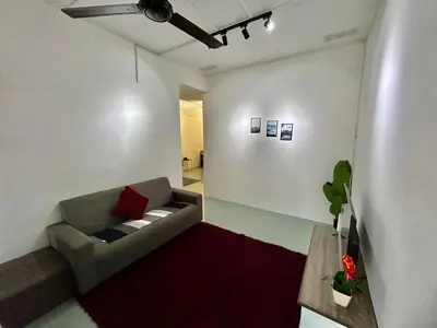 a living room with a couch and a red rug at Cozy24#4pax#wifi&netflix#NearAeonAlma#Heritage in Bukit Mertajam