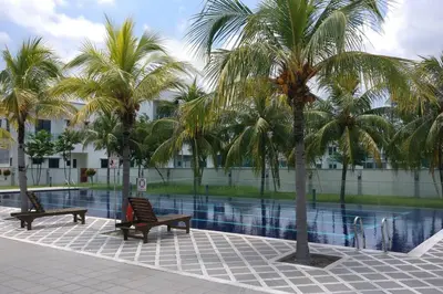 two benches and palm trees next to a swimming pool at Setia Residen Semi-D two half storey 5 Bedrooms unlimited wifi in Sitiawan