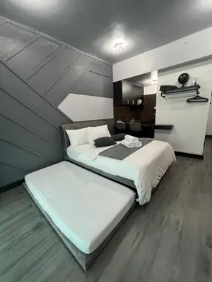 a bedroom with two beds in a room at SAMSARA Studio Apartment at Kompleks Mutiara GM in Gua Musang
