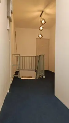 an empty hallway with a staircase in a building at 246housecafe in George Town