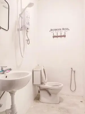 a white bathroom with a toilet and a sink at 246housecafe in George Town