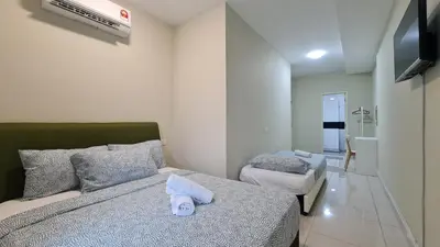 a bedroom with a bed with a towel on it at Rooms at Mansion One, Shared Apartment Only in George Town
