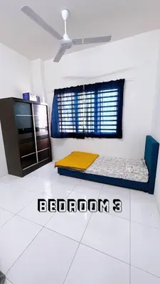 a room with two beds in the corner of a room at HomeSTAY PANGSAPURI SAMUDERA SERI MANJUNG LUMUT in Seri Manjung