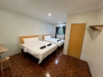 a bedroom with two beds in a room at Homestay Suria in Kuala Kangsar