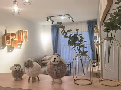 three sheep statues sitting on a table with vases at Emerald Avenue Cozy 1BR Studio Suite in Brinchang