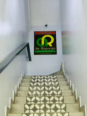 a staircase with a sign on the wall next to a stair case at Ar Rayyan Hotel in Tanah Rata
