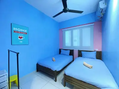 a room with two beds and a ceiling fan at JOVIAL Modern Cozy Homestay `Meritus Perai in Perai