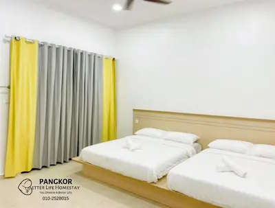 two beds in a room with yellow curtains at Pangkor Villa88 Double Storey 3min to Pasir Bogak Beach in Pangkor