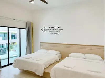 two beds sitting next to each other in a room at Pangkor Villa88 Double Storey 3min to Pasir Bogak Beach in Pangkor