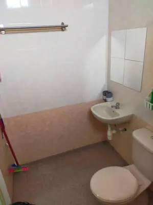 a bathroom with a toilet and a sink at Cheerful 3-Bedroom Residential Home with Free WIFI in Butterworth
