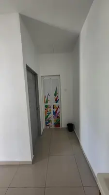 an empty room with white walls and a door at Sri MaLati Homestay and Event Space in Balik Pulau
