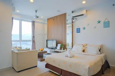 a bedroom with a bed and a chair and a television at Mansion One l 4pax Studio l Cityview l Gleneagle l by PerfectSweetHome in George Town