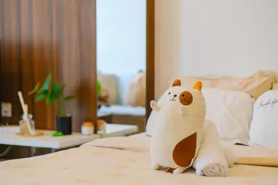 a toy bear sitting on top of a bed at Mansion One l 4pax Studio l Cityview l Gleneagle l by PerfectSweetHome in George Town