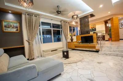 a living room with a couch and a television at Cozy Gurney Georgetown Private Apartment Penang in George Town