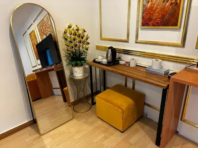 a room with a desk with a television and a mirror at GOA INN HOTEL SDN BHD in Gua Musang
