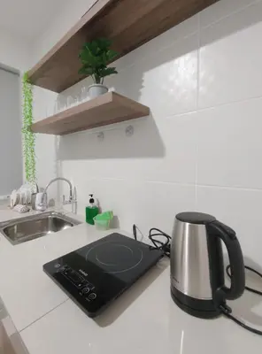 a kitchen counter with a tea kettle and a sink at IPOH Waterpark Homestay By SummerStay 5km to IPOH TOWN in Ipoh
