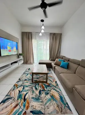 a living room with a couch and a table at Lily King (modern and comfy) in Tanah Rata