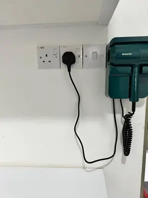a telephone is hanging on a wall in a room at Lily King (modern and comfy) in Tanah Rata