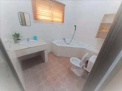 a bathroom with a tub and a toilet and a sink at Cs Villa Homestay in Ipoh