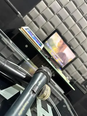 a microphone sitting on a table with a cell phone at Manjung Vermogen Stay-Wi-Fi+KTV(Near Aeon) in Sitiawan