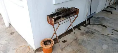 an old instrument sitting on a stand next to a wall at Single Storey Bungalow 12 pax in Ipoh