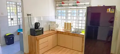 a kitchen with a black refrigerator and a microwave at Single Storey Bungalow 12 pax in Ipoh