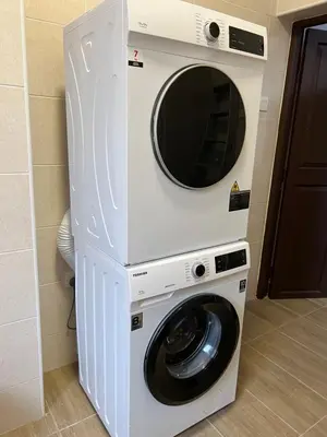 a washer and dryer with a mirror above it at The Neighbour KKB - Rooms with shared bathroom - Whole unit has 4 rooms in Kuala Kubu Baharu