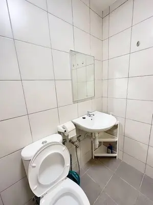 a white bathroom with a toilet and a sink at TheSun #BayanLepas#QueensbayMall#PISA#USM in Bayan Lepas