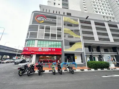 a group of motorcycles parked in front of a building at TheSun #BayanLepas#QueensbayMall#PISA#USM in Bayan Lepas
