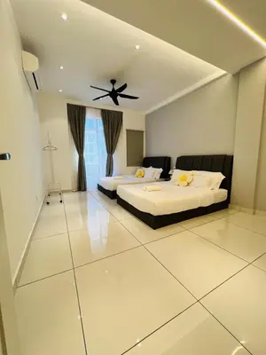 a bedroom with two beds and a ceiling fan at Inn Homestay in Teluk Intan