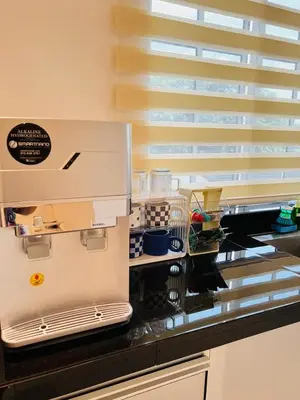 a kitchen with a counter top with aifts at Inn Homestay in Teluk Intan