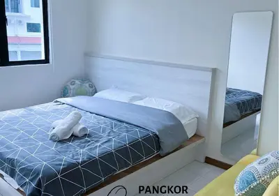 a bedroom with a bed with a teddy bear on it at Better Life Apartment near beach-2room 2bathroom 6pax in Pangkor