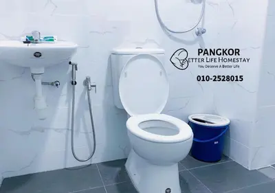 a bathroom with a toilet and a sink at Better Life Apartment near beach-2room 2bathroom 6pax in Pangkor