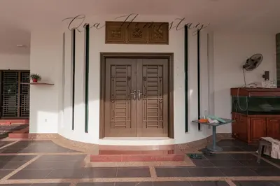 a room with a wooden door on a wall at Qua Homestay 5 Rooms 6 Bathrooms in Taiping