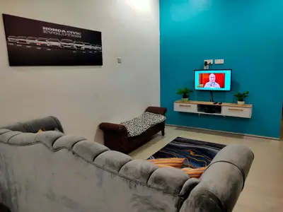 a living room with a couch and a tv at SALAM Homestay D'Gerik in Gerik