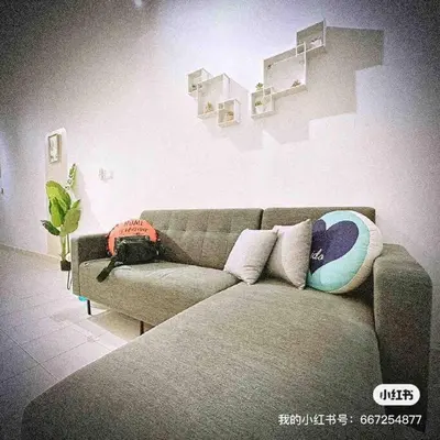 a living room with a couch with pillows at Nordic Home Falim 31 Astro in Ipoh