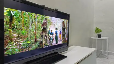 a flat screen tv sitting on top of a table at Casa Indera in Kampung Bota Kiri