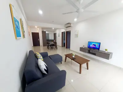 a living room with a blue couch and a table at LOVELY 2ROOM SUITE6PAX@SKY CONDO JURU SENTRAL in Bukit Mertajam